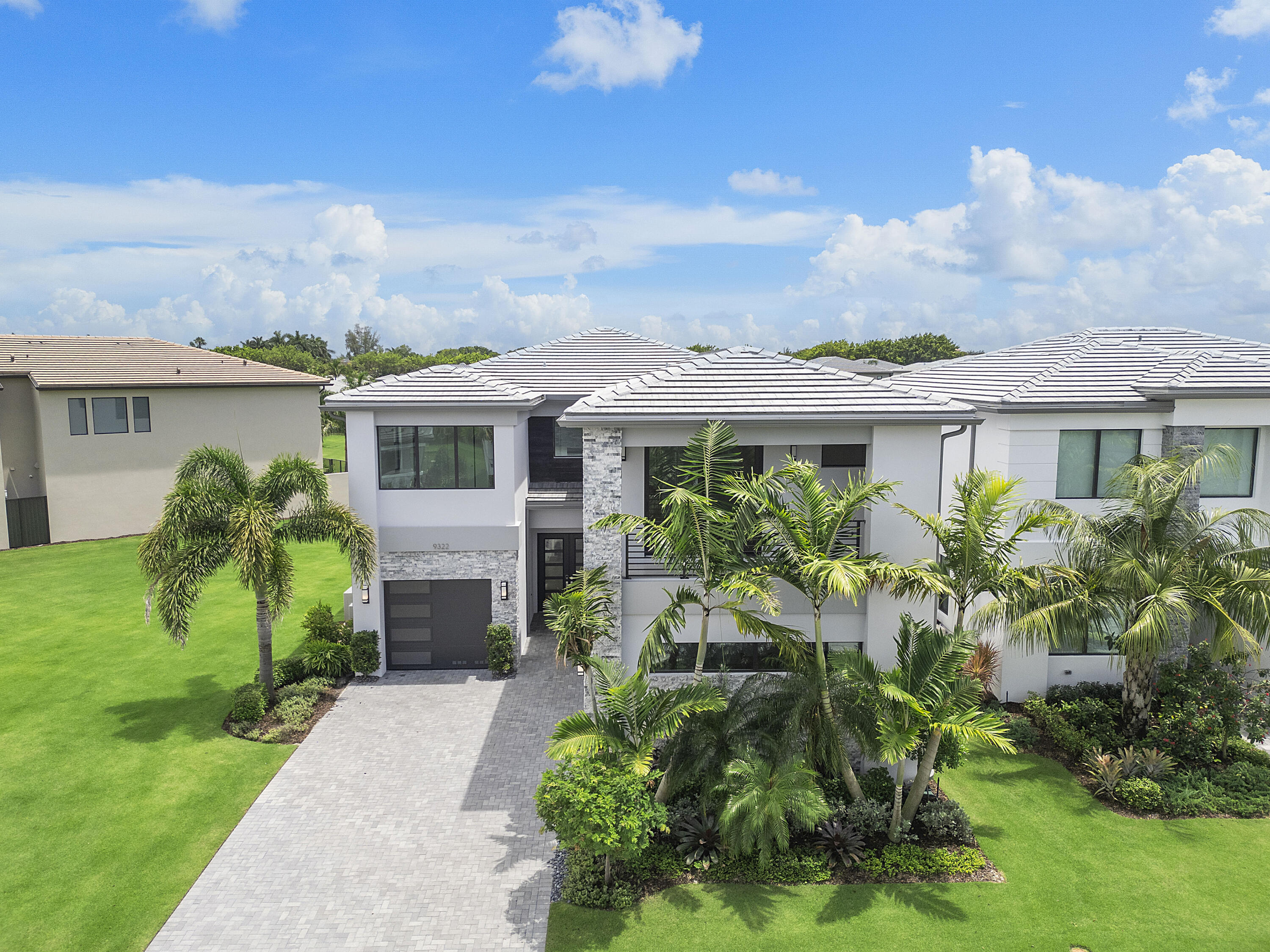 9322 Sunflower Mdw Road Boca Raton, FL 33434 - Photo 6 of 87 a front view of a house with a garden