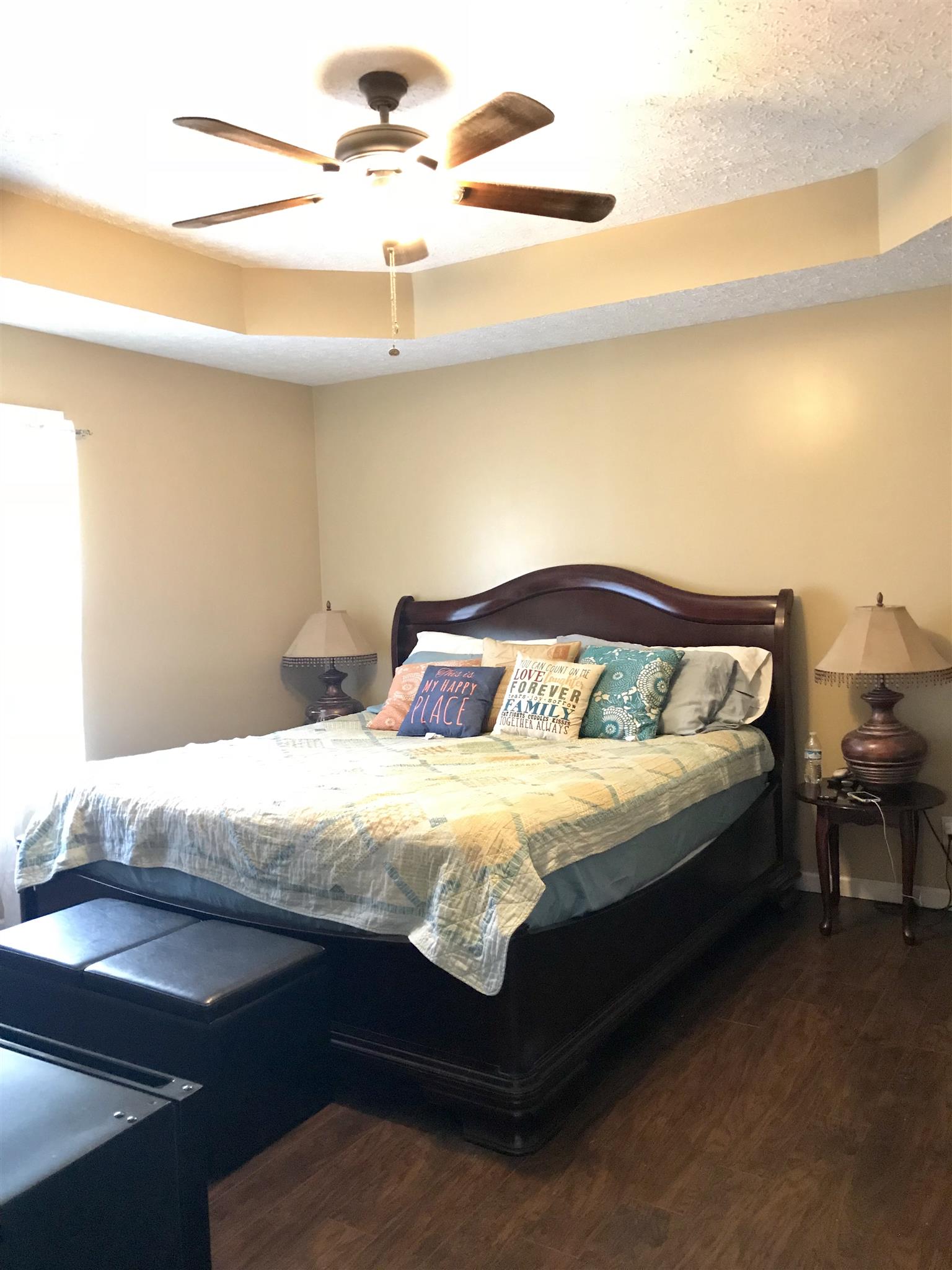 372 Jernigan Road Portland, TN 37148 - Photo 8 of 10 a spacious bedroom with a bed and a chandelier