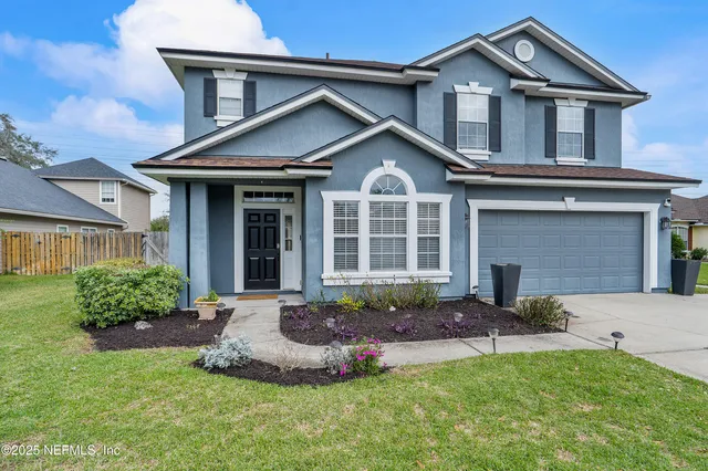 a front view of a house with a yard and outdoor seating