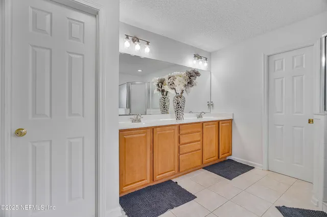 a spacious bathroom with a mirror and a sink