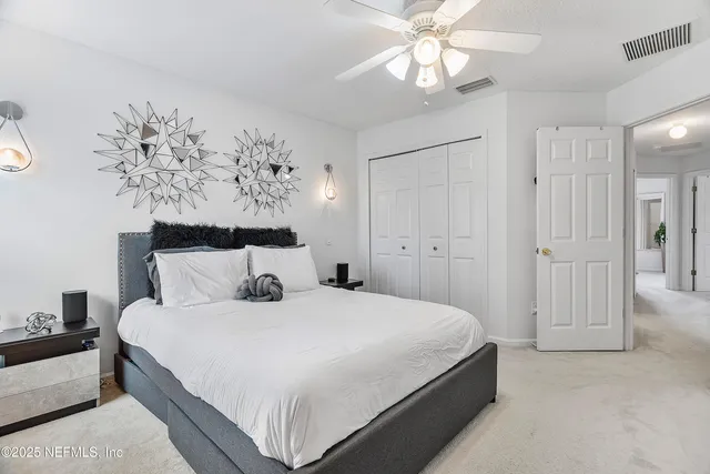 a bedroom with bed and a chandelier