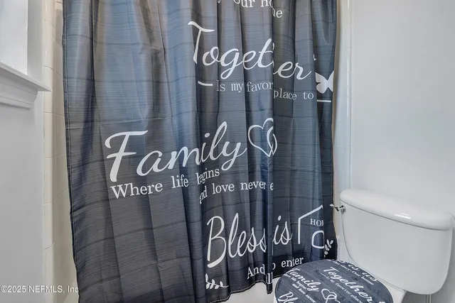 a bathroom with a toilet and shower