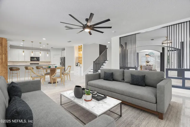 a living room with furniture and kitchen view