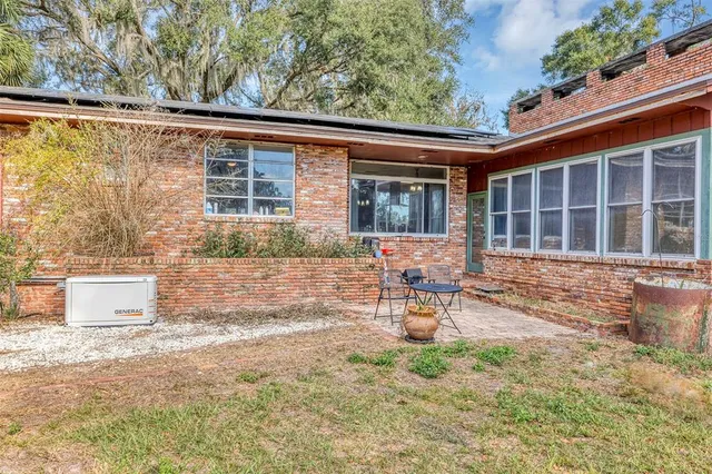 a dining room with furniture a chandelier and window