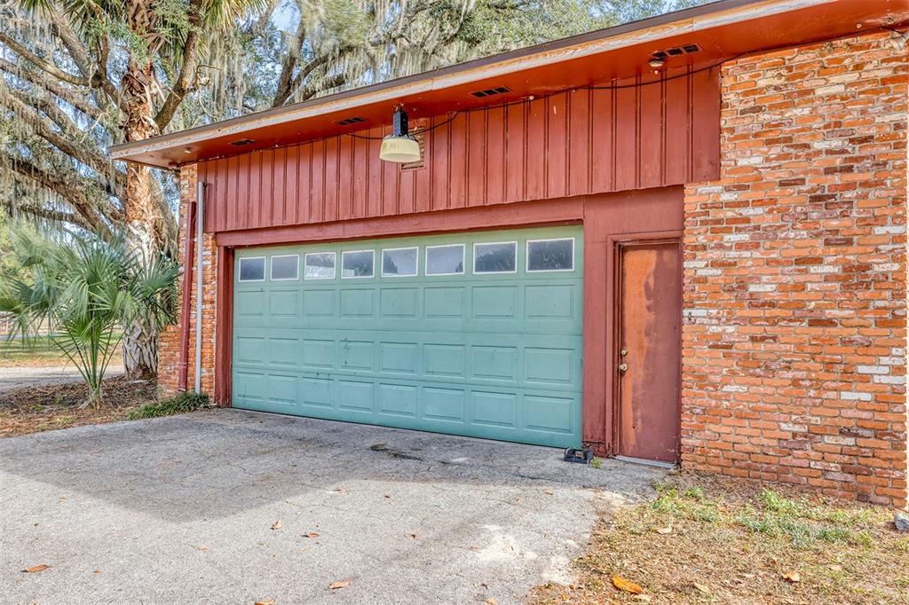 208 Northeast 70th Street Ocala, FL 34475 - Photo 28 of 71 a front view of a house with a garage