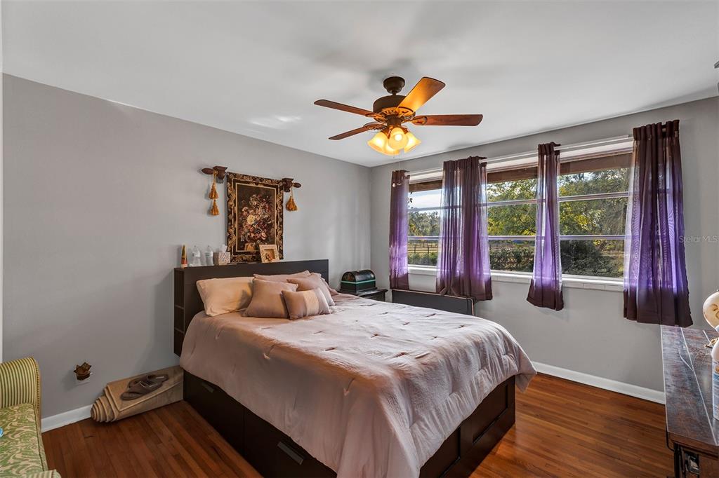 208 Northeast 70th Street Ocala, FL 34475 - Photo 38 of 71 a bedroom with a bed and a large window