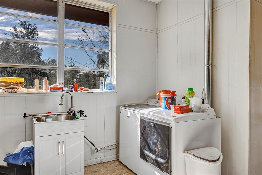 208 Northeast 70th Street Ocala, FL 34475 - Photo 50 of 71 a utility room with sink washer and dryer
