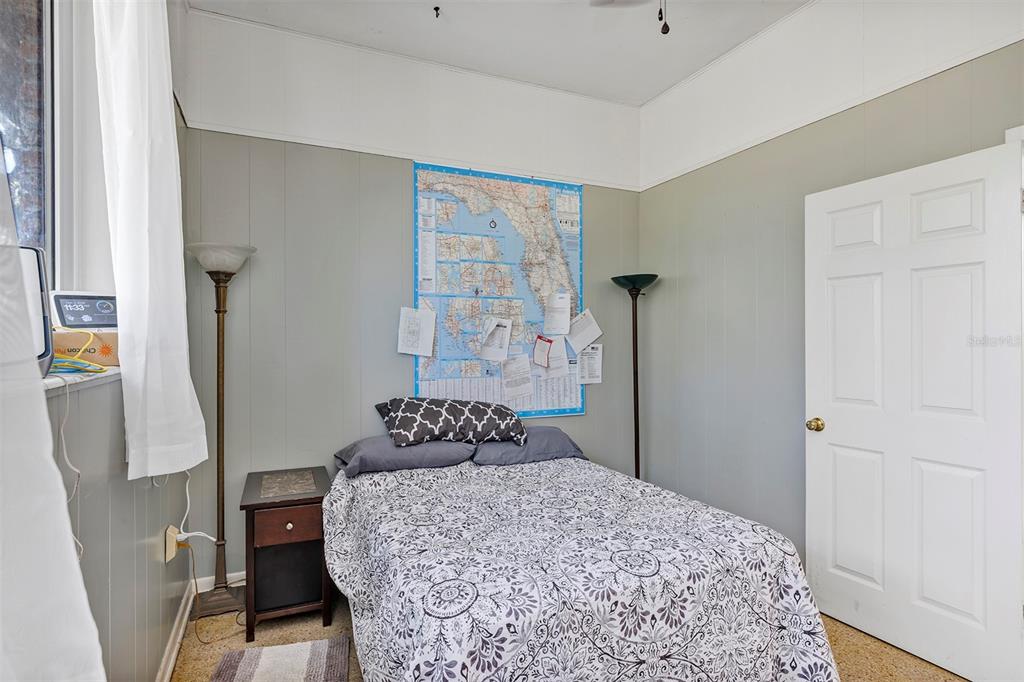 208 Northeast 70th Street Ocala, FL 34475 - Photo 52 of 71 a bedroom with a bed and a dresser