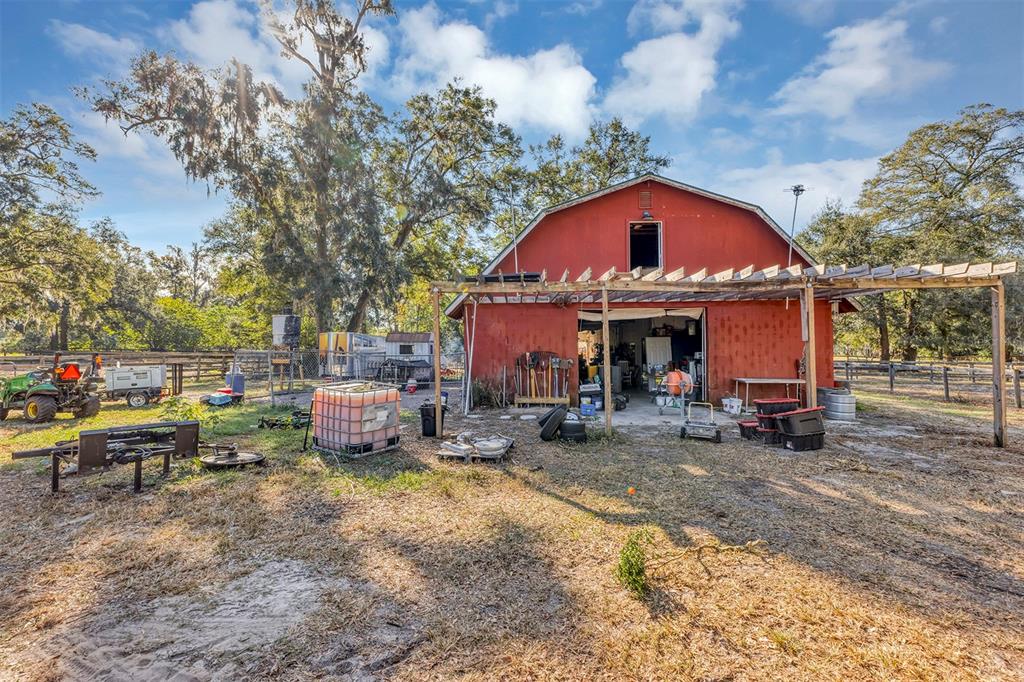 208 Northeast 70th Street Ocala, FL 34475 - Photo 6 of 71 a view of a house with backyard sitting area and garden