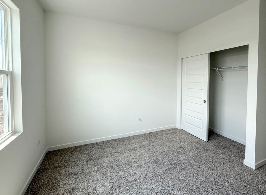 2459 Scribe Street Oswego, IL 60543 - Photo 12 of 26 an empty room with a empty space and windows