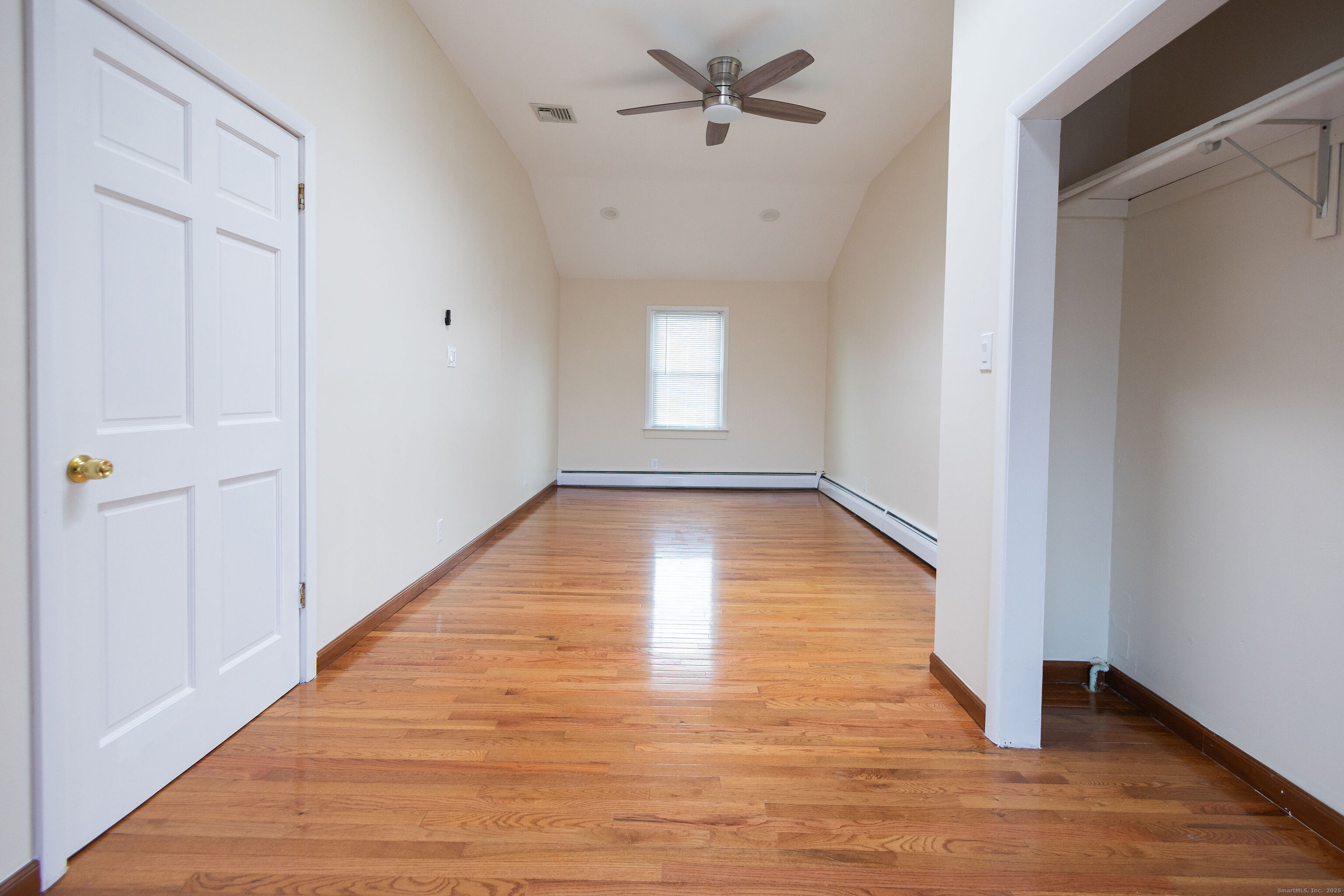 138 Infield Street Bridgeport, CT 06606 - Photo 13 of 31 a view of an empty room with wooden floor and a window