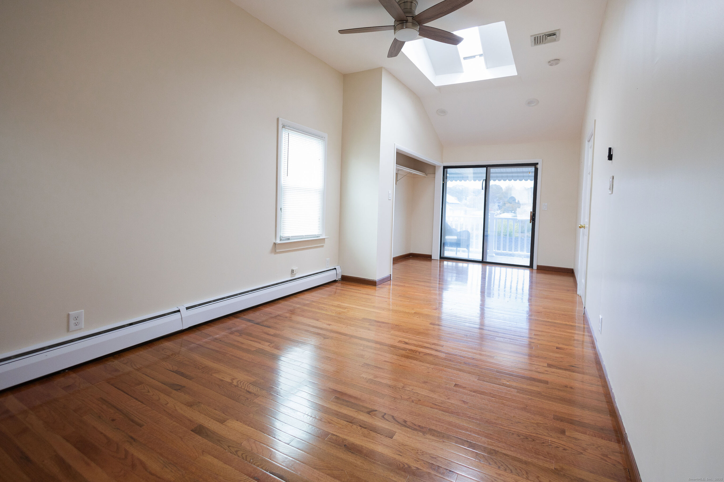 138 Infield Street Bridgeport, CT 06606 - Photo 14 of 31 an empty room with wooden floor and windows