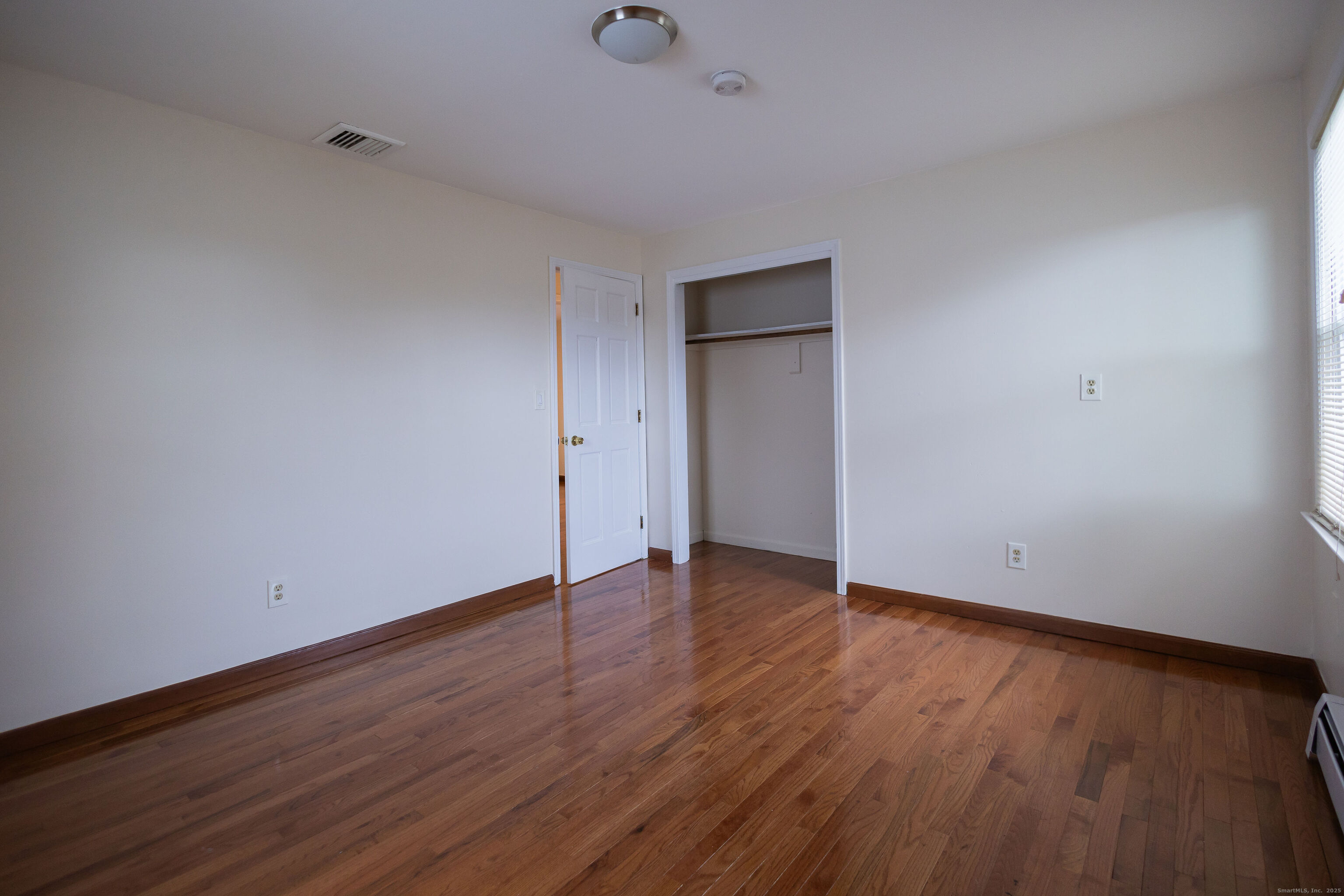 138 Infield Street Bridgeport, CT 06606 - Photo 22 of 31 a view of an empty room with wooden floor and closet