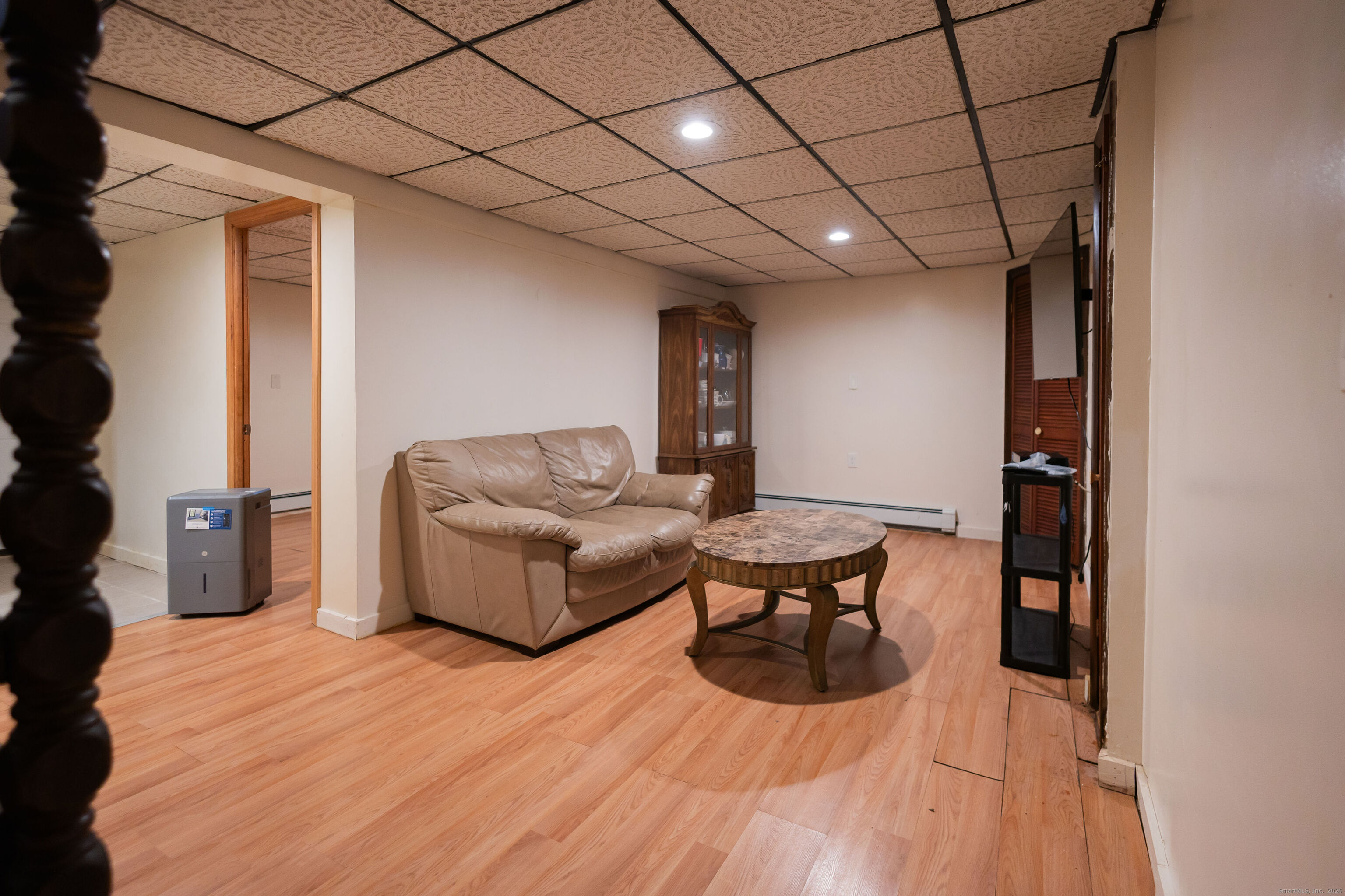 138 Infield Street Bridgeport, CT 06606 - Photo 24 of 31 a living room with furniture a flat screen tv and a wooden floor