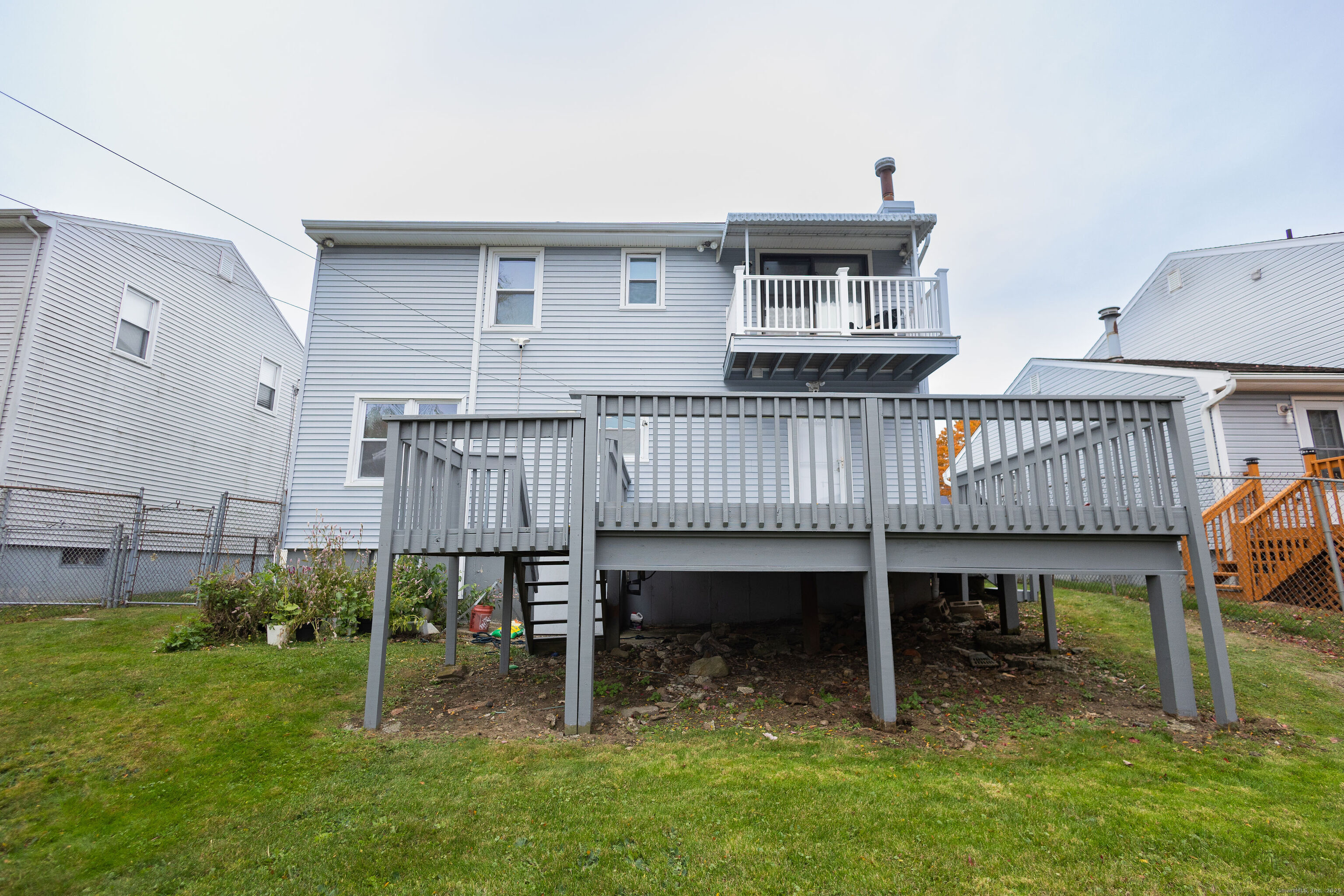 138 Infield Street Bridgeport, CT 06606 - Photo 4 of 31 a view of a deck with a table and chairs with wooden fence