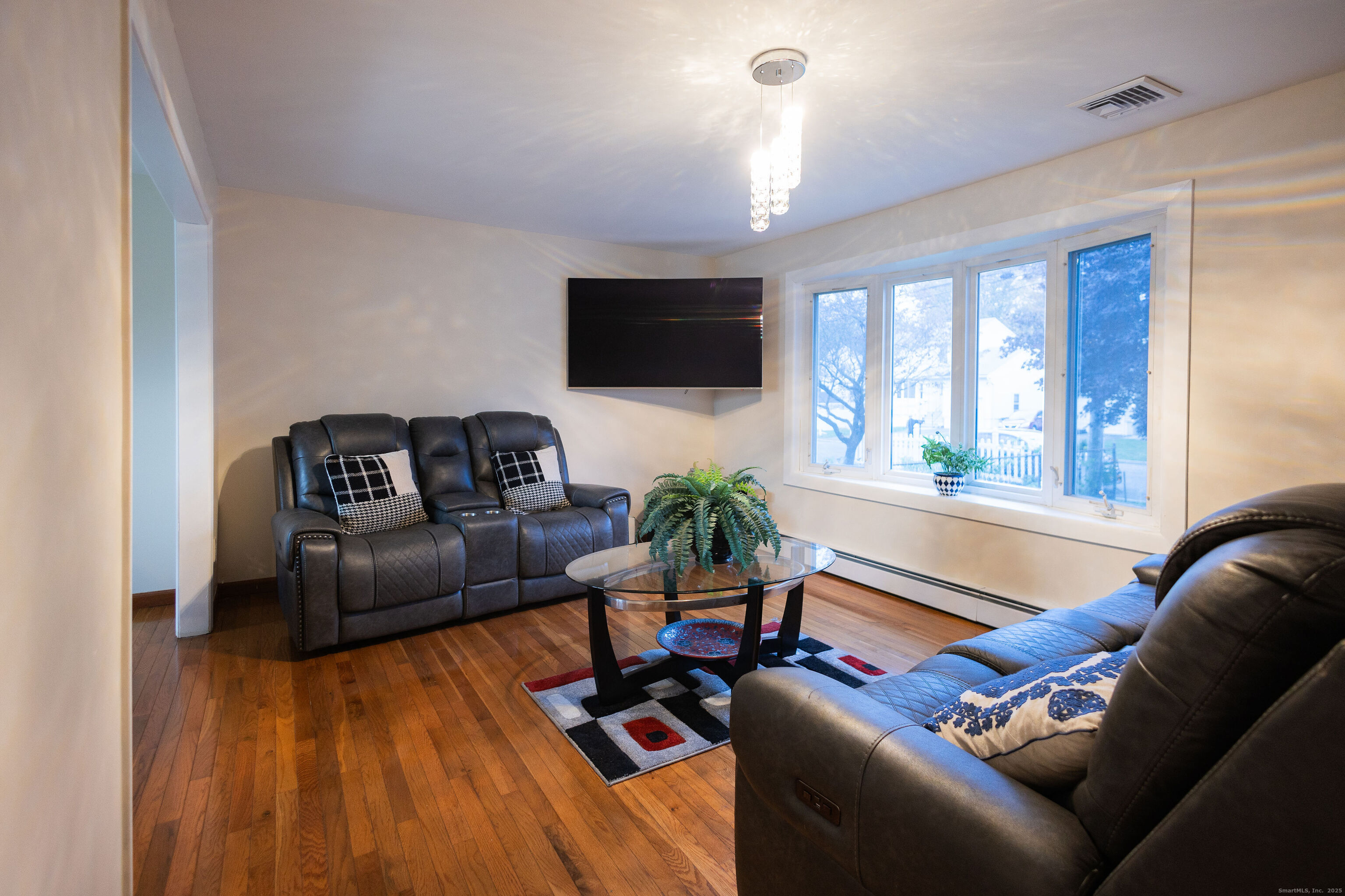 138 Infield Street Bridgeport, CT 06606 - Photo 5 of 31 a living room with furniture and a flat screen tv
