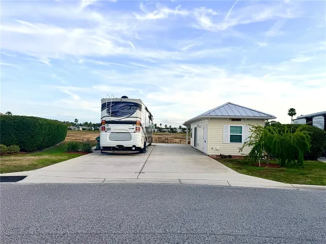 a car parked in front of a house with a yard