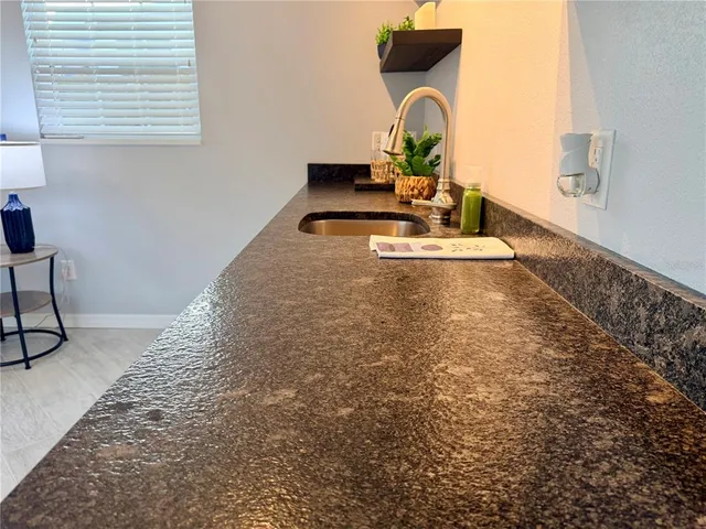 a view of a sink storage and a window