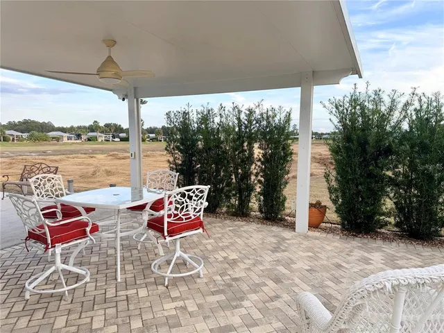 a patio with water view fountain and a lake view