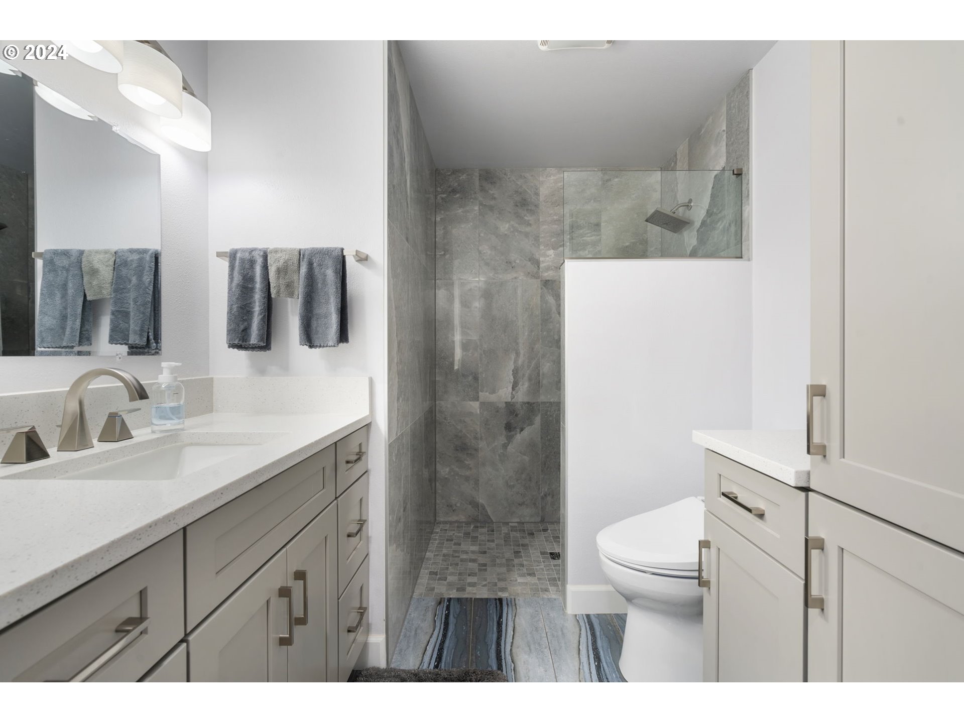 4409 Southwest Kanan Drive Portland, OR 97221 - Photo 11 of 25 a bathroom with a sink a toilet and mirror