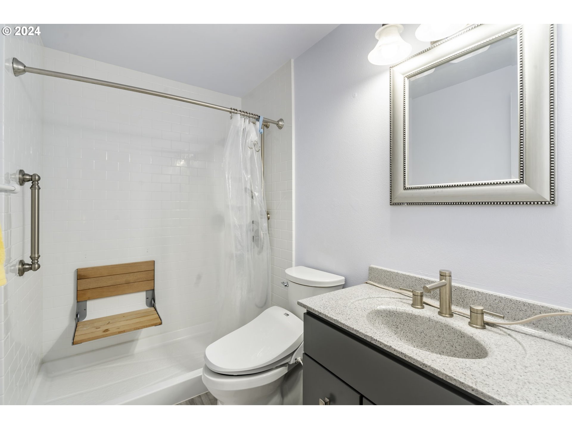 4409 Southwest Kanan Drive Portland, OR 97221 - Photo 15 of 25 a bathroom with a granite countertop sink toilet and shower