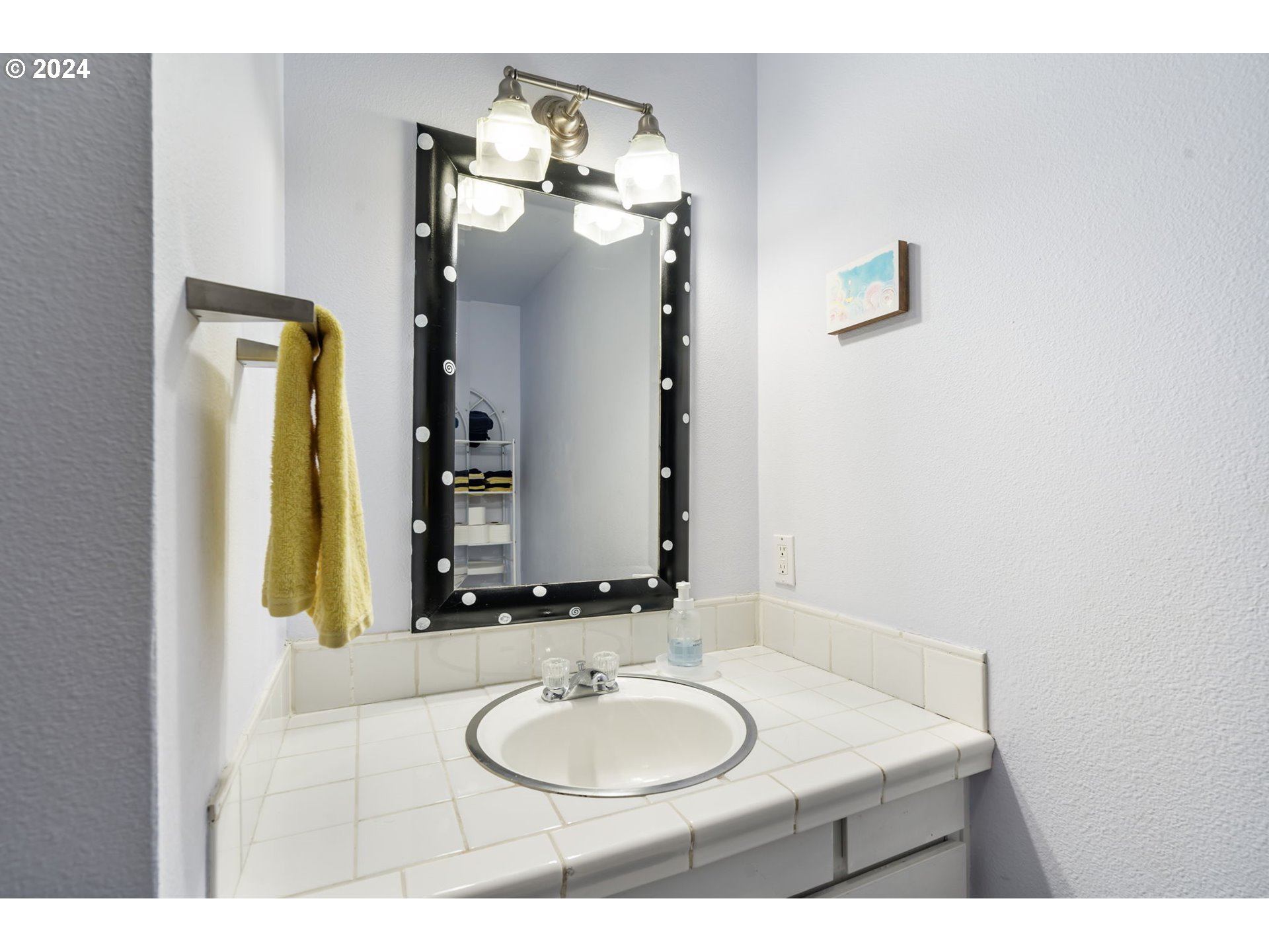 4409 Southwest Kanan Drive Portland, OR 97221 - Photo 17 of 25 a bathroom with a sink and a mirror