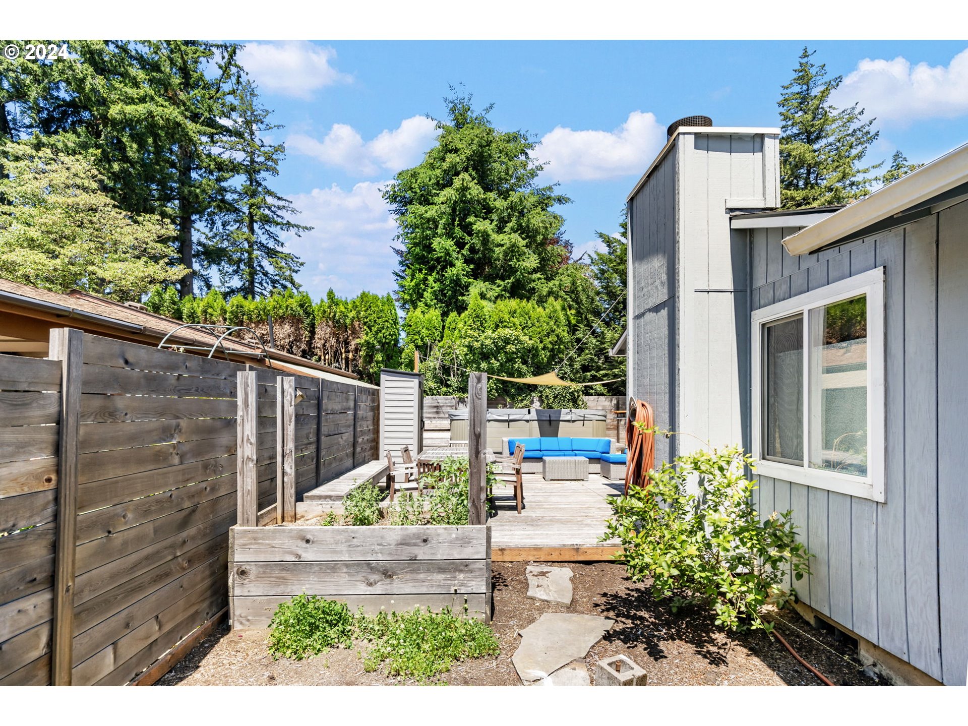 4409 Southwest Kanan Drive Portland, OR 97221 - Photo 21 of 25 a view of a house with a small yard and potted plants