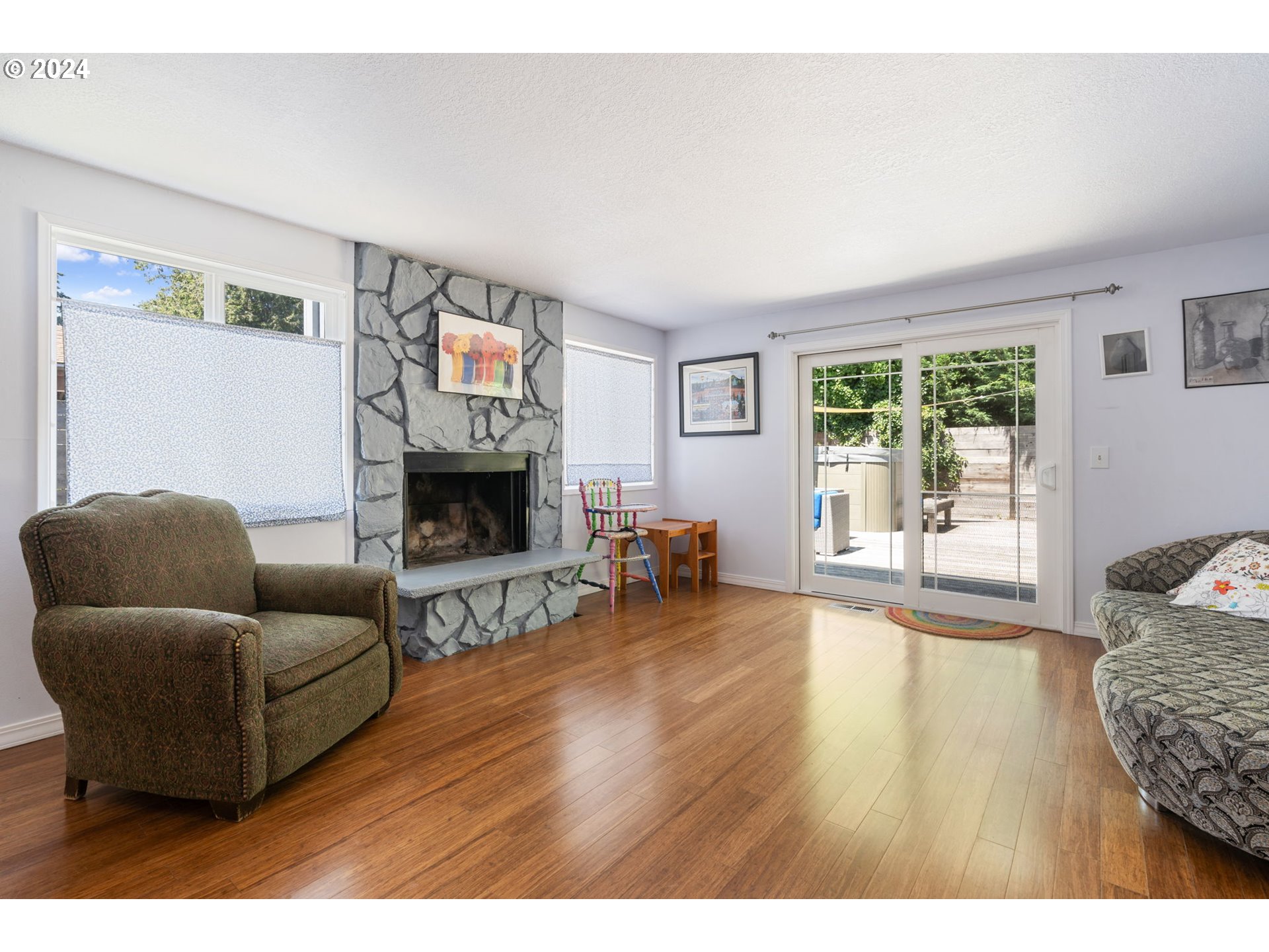 4409 Southwest Kanan Drive Portland, OR 97221 - Photo 8 of 25 a living room with furniture and a fireplace
