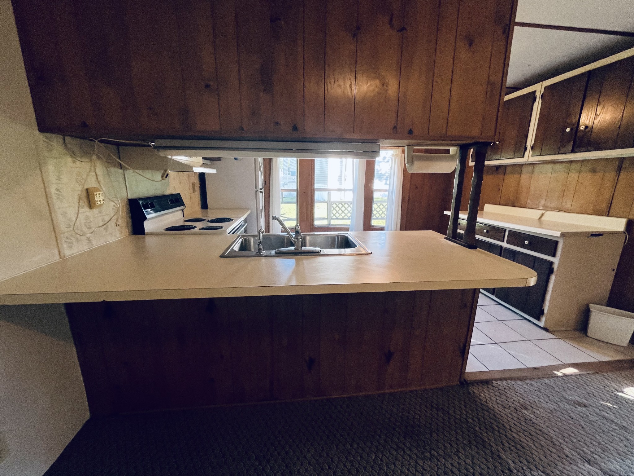 294 Ridgeway Drive Sugar Tree, TN 38380 - Photo 20 of 28 a kitchen with wooden cabinets a sink and a stove