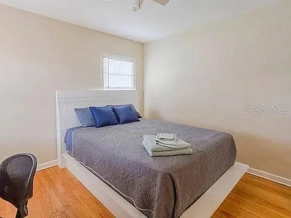 a bed sitting in a bedroom next to a window