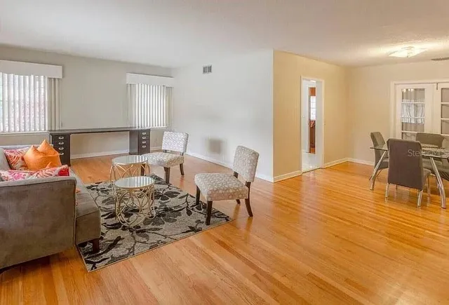 a living room with furniture and wooden floor