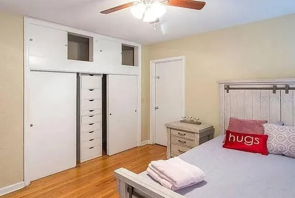 a bedroom with a bed and a dresser