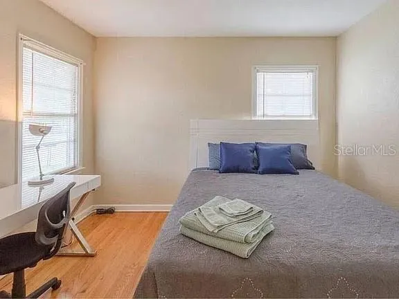 a bedroom with a bed and window