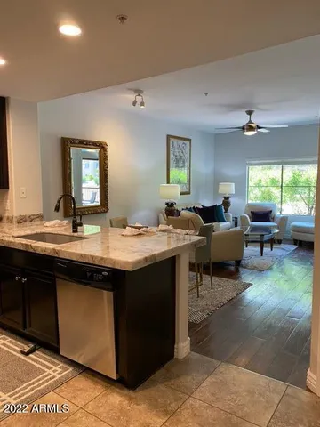 a living room with sink furniture and a large window