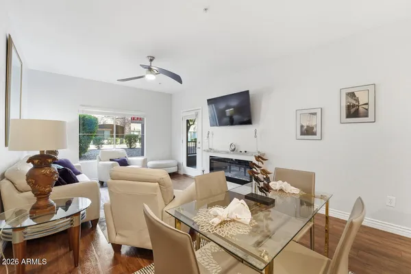 a living room with furniture a flat screen tv and a dining table