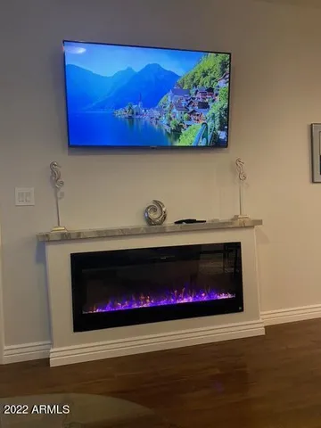 a room with a fireplace and wooden floor