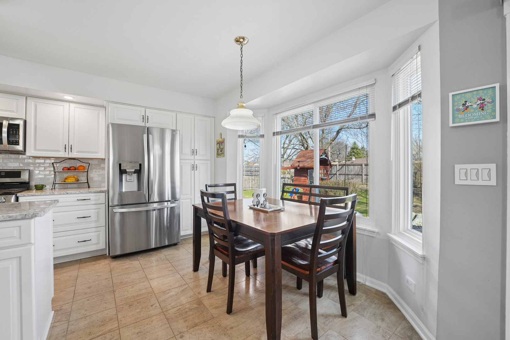 829 Renaissance Drive Carol Stream, IL 60188 - Photo 11 of 35 a kitchen with refrigerator cabinets dining table and chairs