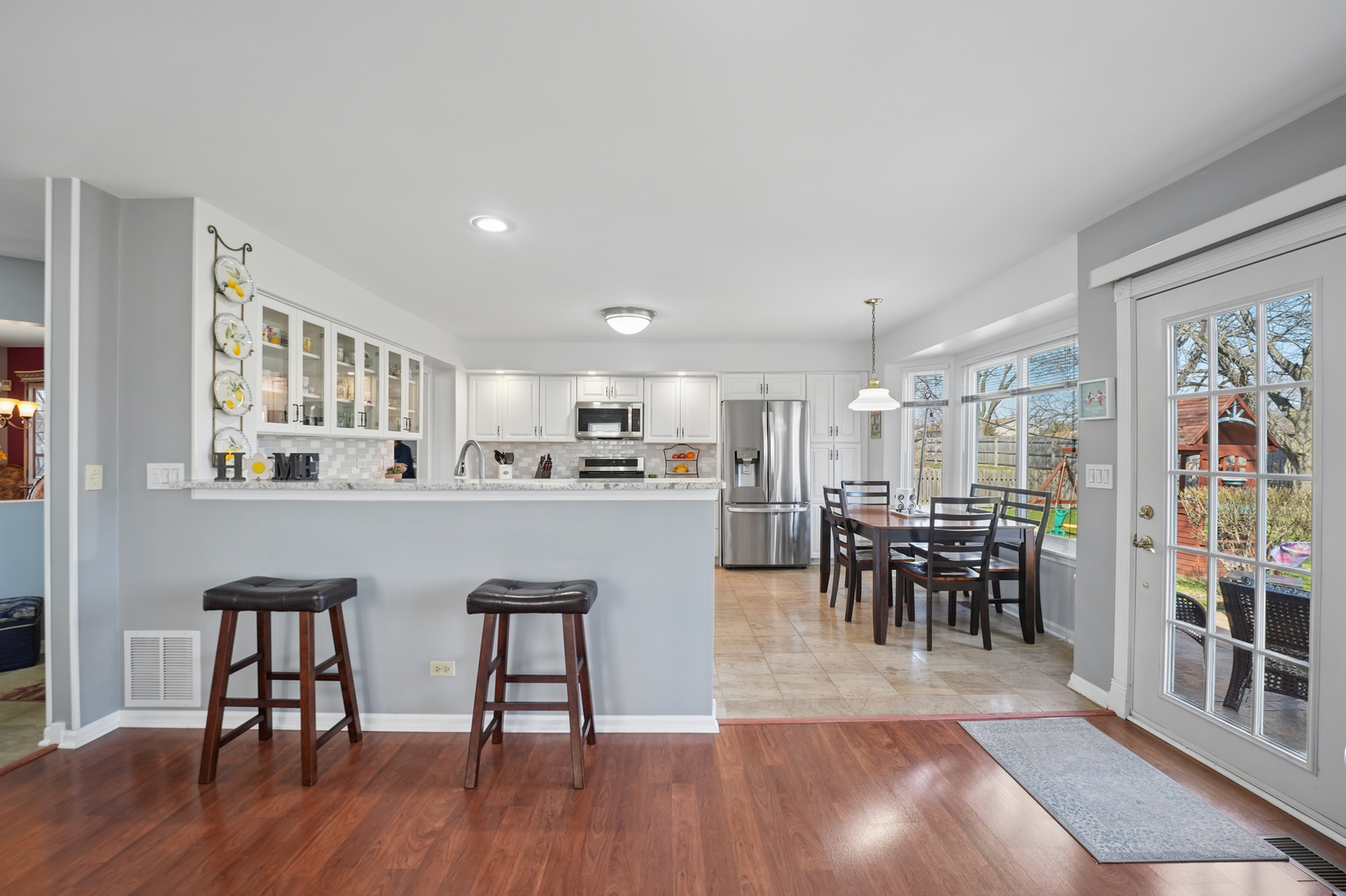 829 Renaissance Drive Carol Stream, IL 60188 - Photo 12 of 35 a living room with stainless steel appliances kitchen island granite countertop furniture and a dining table
