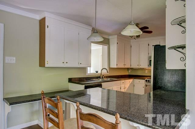 2109 Winkler Road Durham, NC 27712 - Photo 11 of 21 a kitchen with stainless steel appliances granite countertop a sink a stove and cabinets
