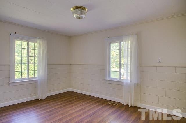 2109 Winkler Road Durham, NC 27712 - Photo 18 of 21 an empty room with wooden floor and windows