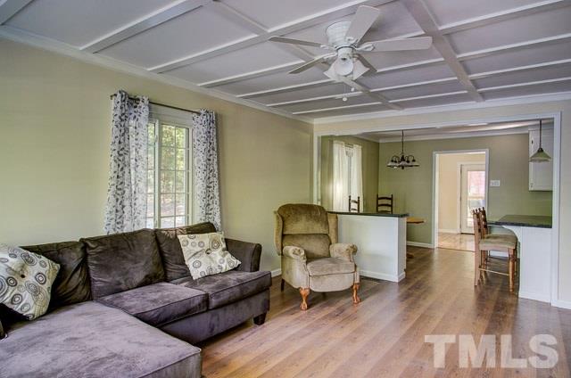 2109 Winkler Road Durham, NC 27712 - Photo 6 of 21 a living room with furniture and a chandelier