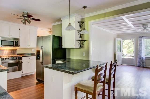 2109 Winkler Road Durham, NC 27712 - Photo 9 of 21 a kitchen with stainless steel appliances granite countertop a stove a refrigerator and a sink