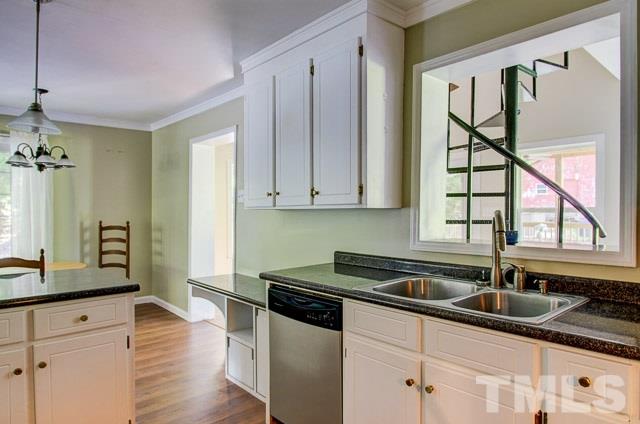2109 Winkler Road Durham, NC 27712 - Photo 10 of 21 a kitchen with granite countertop a sink a stove and cabinets