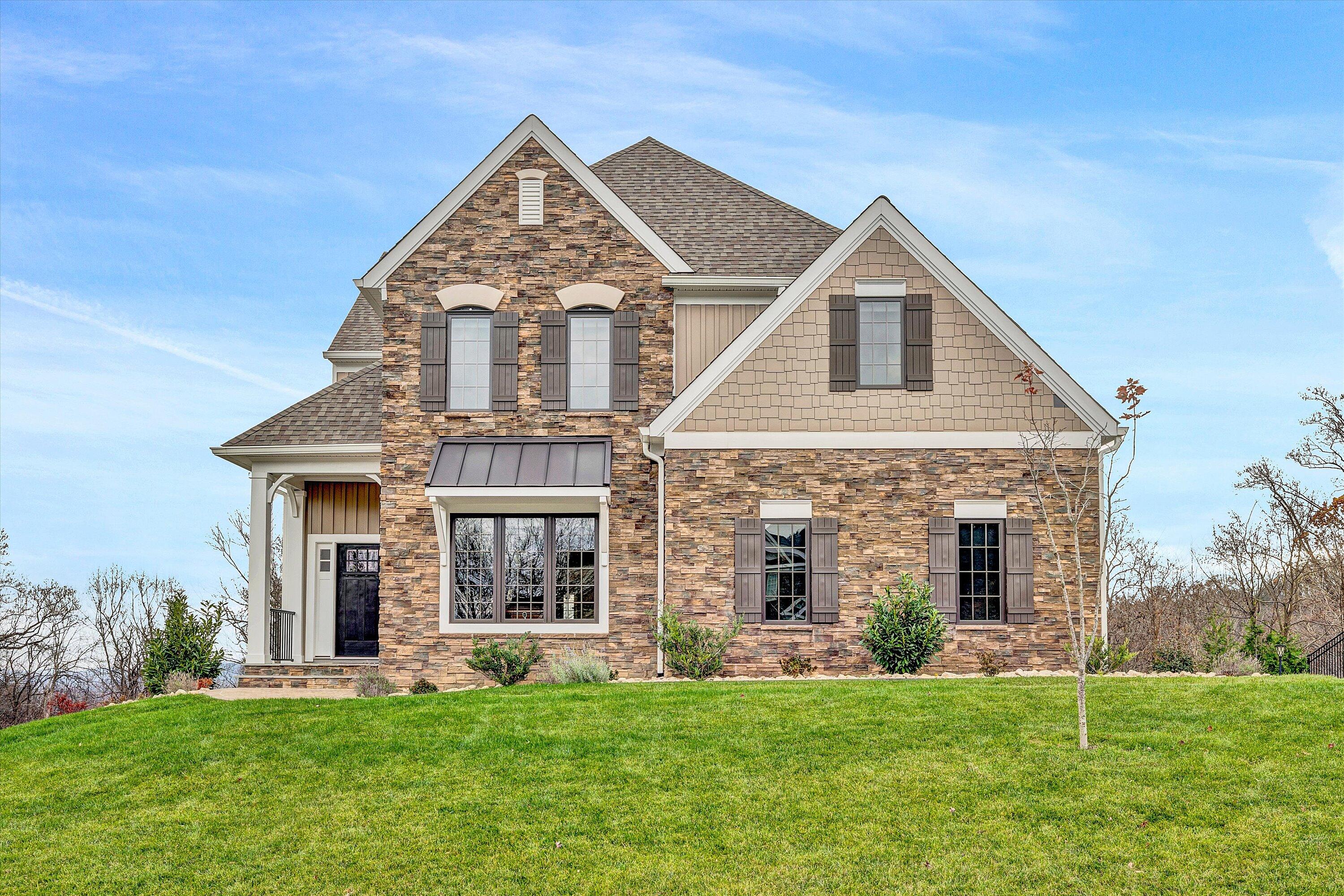 a front view of a house with a yard