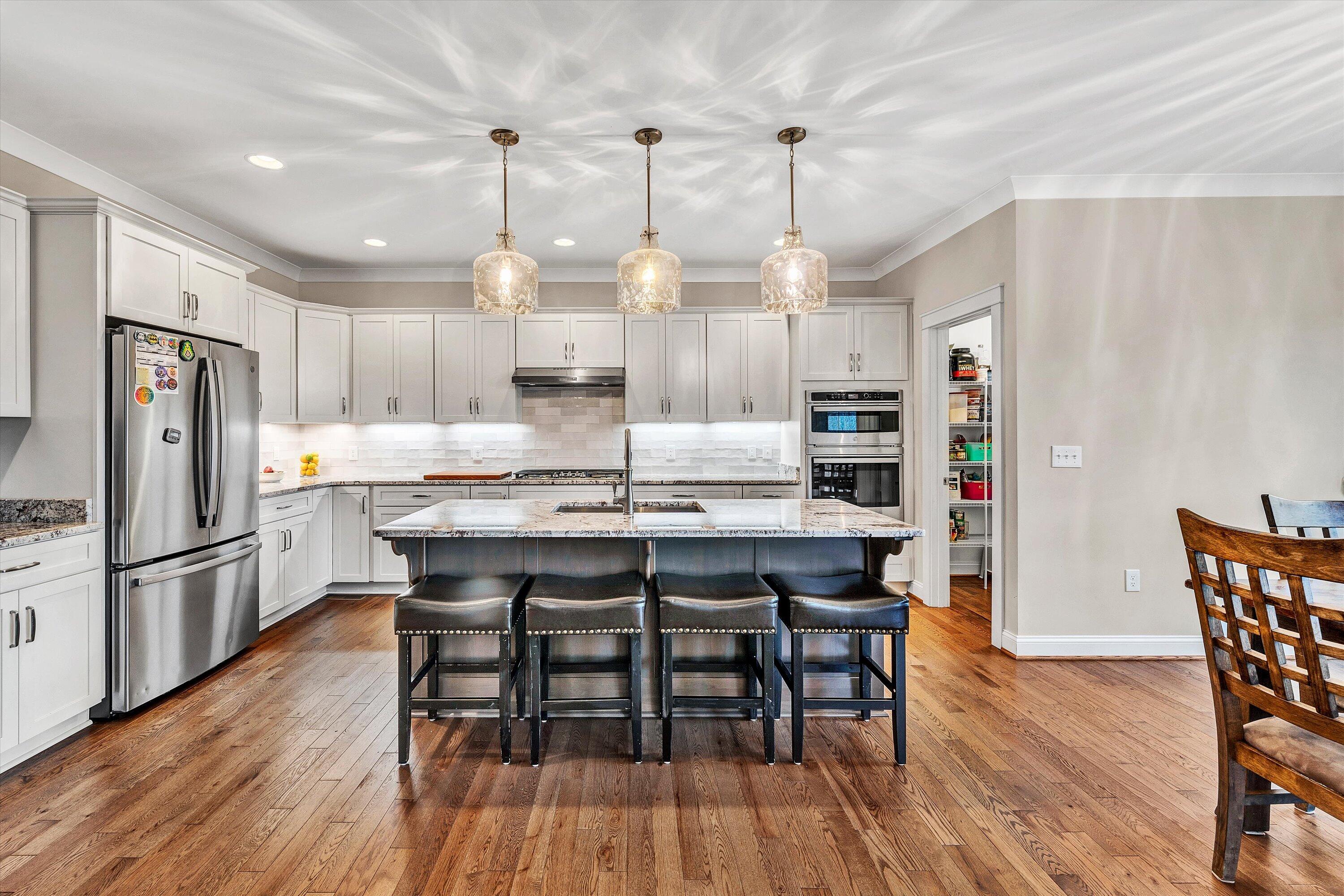 6901 Fairway Ridge Road Salem, VA 24153 - Photo 12 of 58 a kitchen with stainless steel appliances granite countertop a dining table chairs refrigerator and microwave