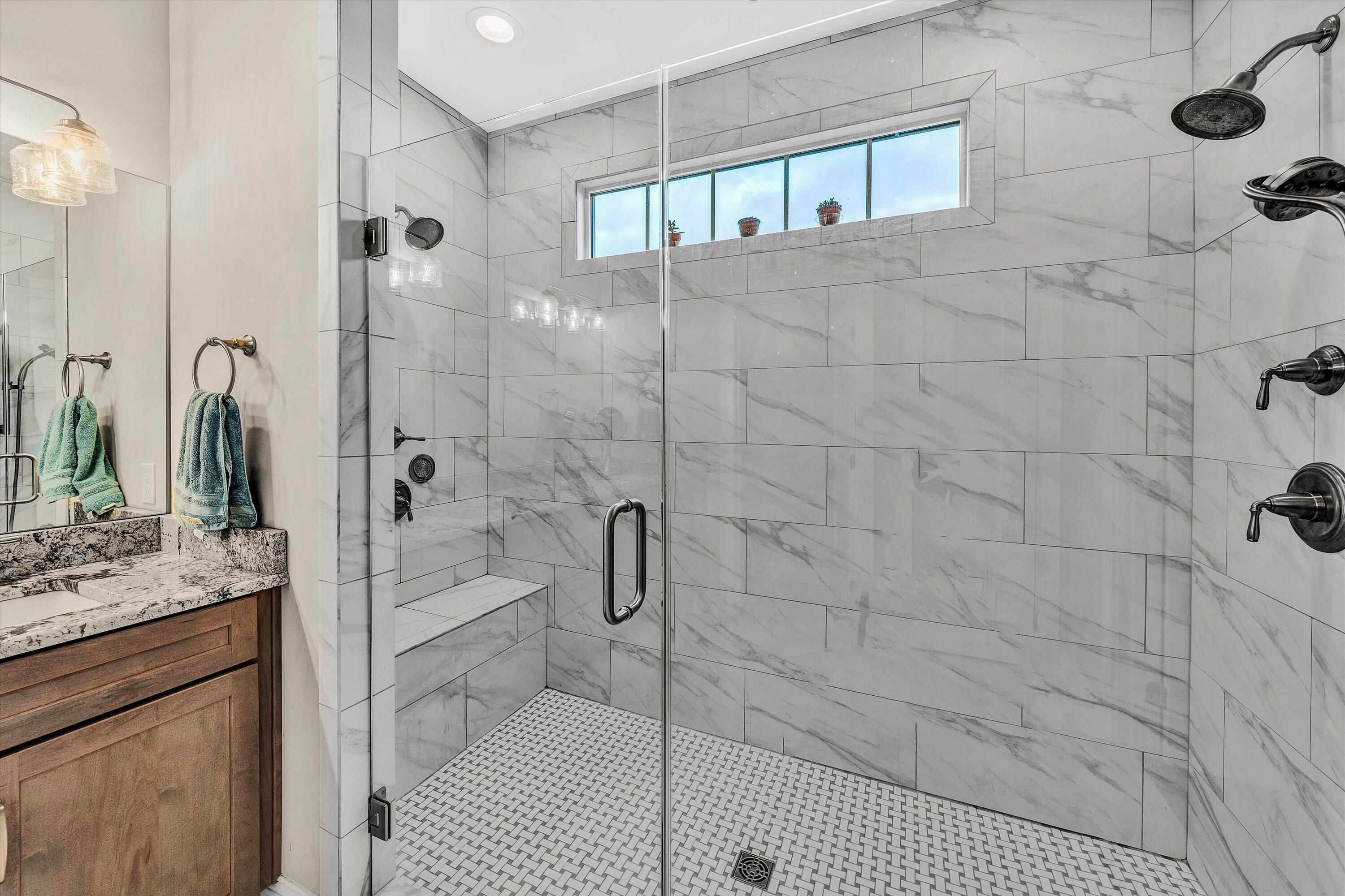 6901 Fairway Ridge Road Salem, VA 24153 - Photo 36 of 58 a bathroom with a granite countertop shower a mirror and a sink
