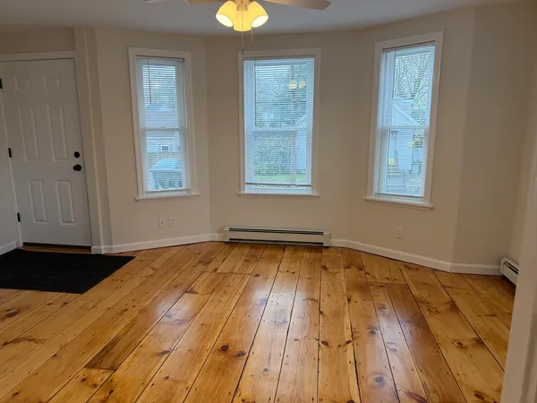 a view of an empty room and wooden floor