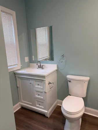 a bathroom with a sink toilet and a mirror