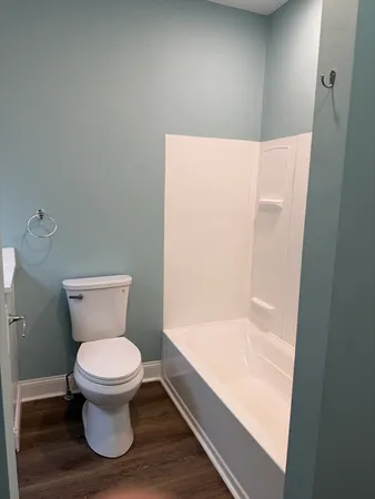 a bathroom with a toilet and a shower