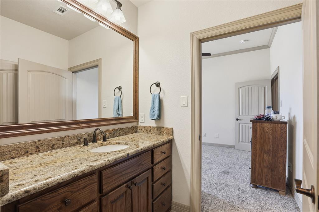 842 County Road 4371 Decatur, TX 76234 - Photo 11 of 35 a bathroom with a granite countertop sink and a mirror